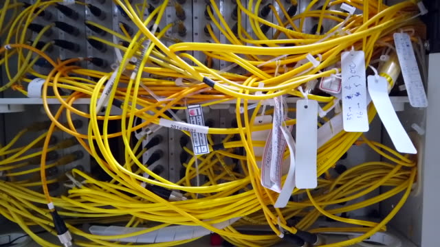 Fiber optic cable connected to enclosure box in a technology data center room for high speed communication