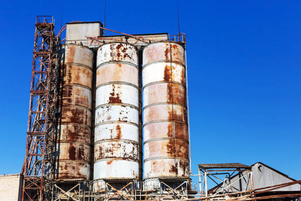istock Old, abandoned concrete plant with iron rusty tanks and metal structures. The crisis, the fall of the economy, stop production capacity led to the collapse. Global catastrophe. 1276943900