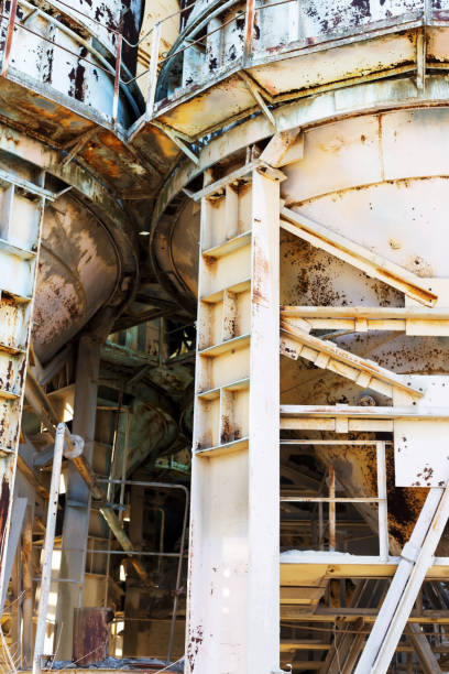 istock Old, abandoned concrete plant with iron rusty tanks and metal structures. The crisis, the fall of the economy, stop production capacity led to the collapse. Global catastrophe. 1276943905