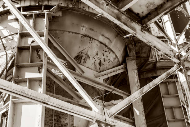 istock Old, abandoned concrete plant with iron rusty tanks and metal structures. The crisis, the fall of the economy, stop production capacity led to the collapse. Global catastrophe. Old photo effect 1276944164