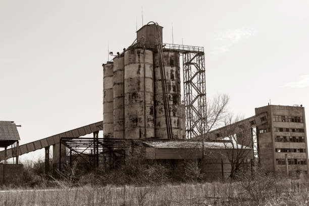 istock Old, abandoned concrete plant with iron rusty tanks and metal structures. The crisis, the fall of the economy, stop production capacity led to the collapse. Global catastrophe. 1276944201