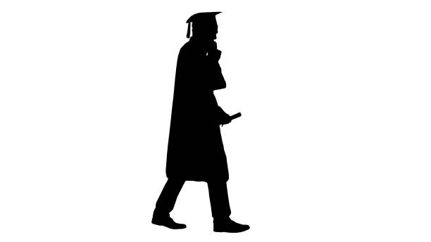 istock Silhouette Smiling male student in graduation robe walking and m 1276944260