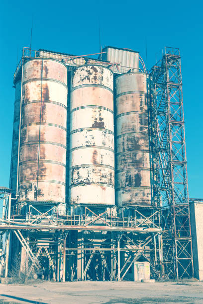 istock Old, abandoned concrete plant with iron rusty tanks and metal structures. The crisis, the fall of the economy, stop production capacity led to the collapse. Global catastrophe. 1276945199