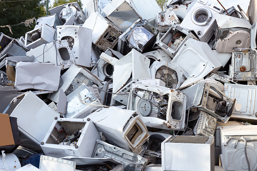 Portrait of a happy man working in a recycling factory sorting the garbage - environmental concepts