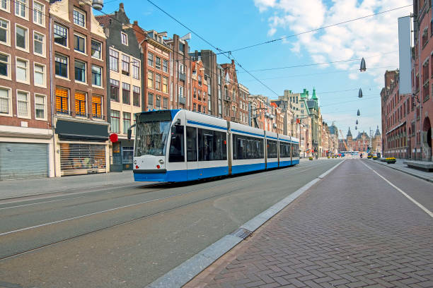 istock Tram driving at Damrak in Amsterdam the Netherlands 1276947833