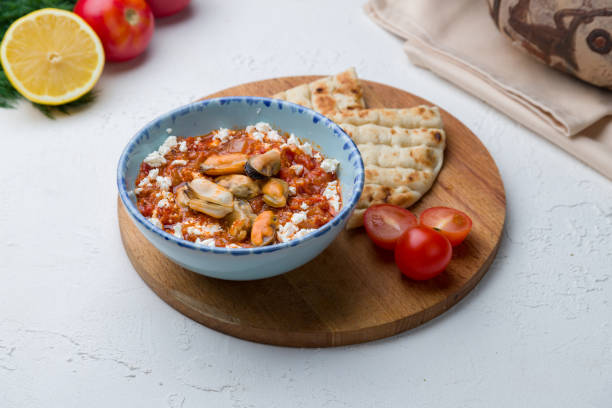 istock saganaki mussels Greek cuisine on white concrete table 1276950522