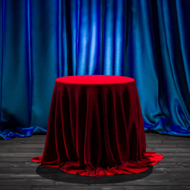 istock Table With Red Cloth Above It And Blue Curtains On Background. Copy Space. Empty Space. 3d Rendering 1276951177