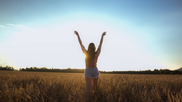 istock Happy woman on wheat field 1276951194