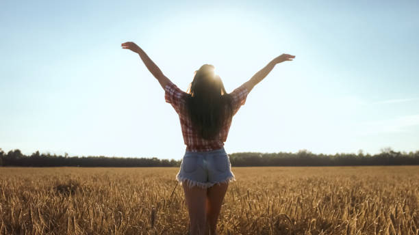 istock Happy woman on wheat field 1276951229