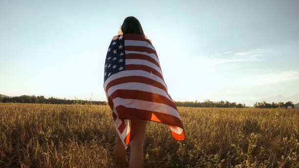 istock Young woman waves an american flag 1276951267