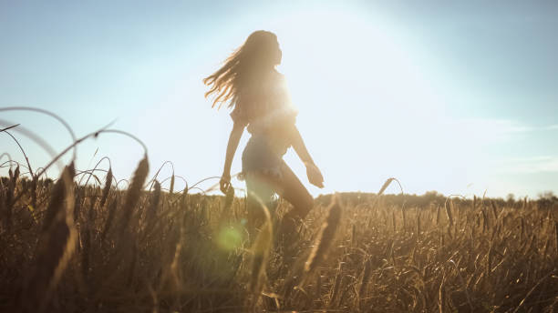istock Happy woman on wheat field 1276951279