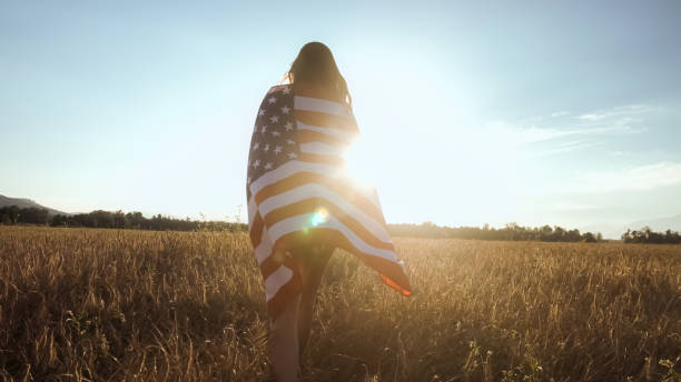 istock Young woman waves an american flag 1276951299