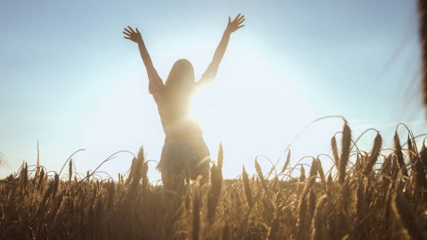istock Happy woman on wheat field 1276951838