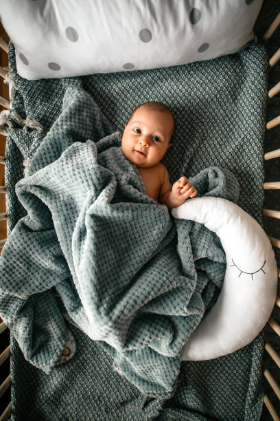 istock Cute baby in her crib 1276952633
