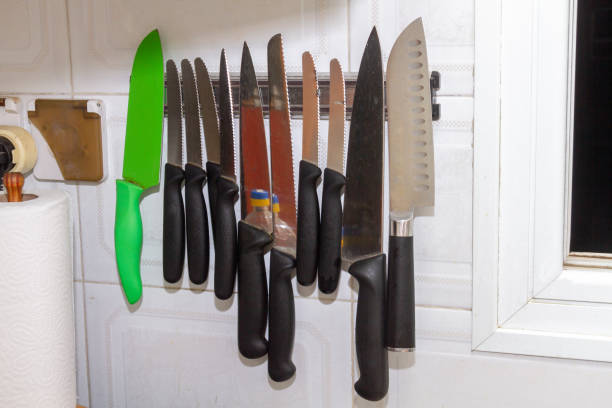 The knives are magnetically attached to the kitchen wall.
