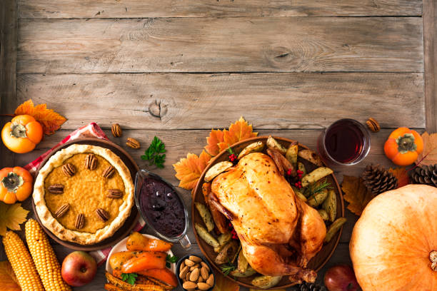 Thanksgiving Turkey Dinner Thanksgiving dinner with chicken, cranberry sauce, pumpkin pie, wine, seasonal vegetables and fruits on wooden table, copy space. Traditional autumn holiday food concept. happy thanksgiving stock pictures, royalty-free photos & images