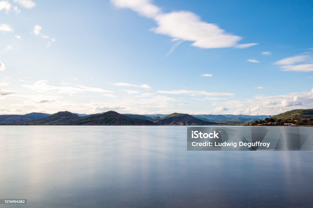 Long exposure view over the Lac du Salagou in cloudy weather (Occitanie, France) Long exposure view over the Lac du Salagou in cloudy weather Beauty Stock Photo