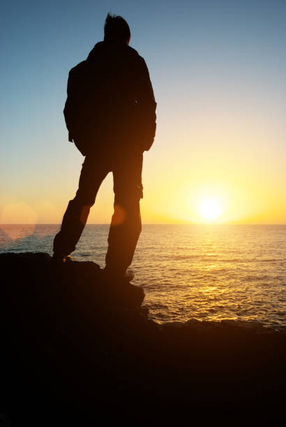 istock Man stands on the edge at sea 1276955619