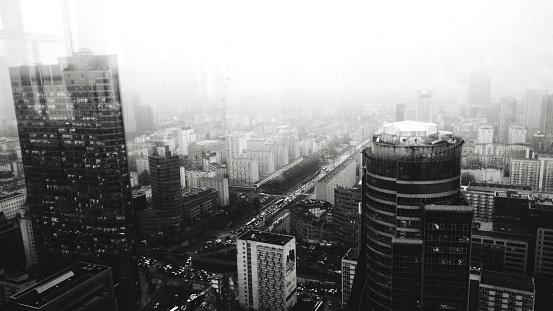 Rainy city seen from above filled with clouds