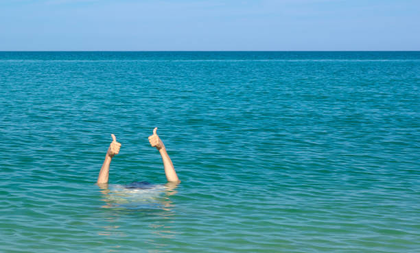 istock Thumb up sign from sea water. 1276955910