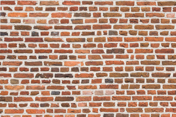 istock Full-frame red old brick wall horizontal image with old colorful stones 1276958131