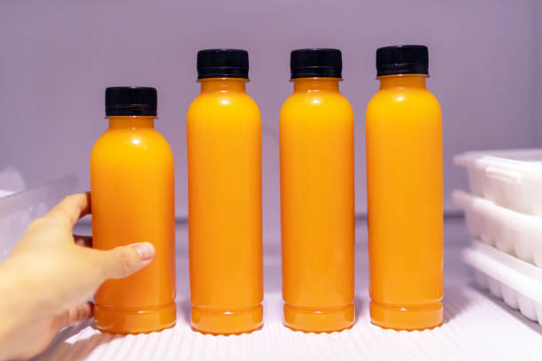 istock Bottle of orange juice in refrigerator get ready for summer. 1276958149