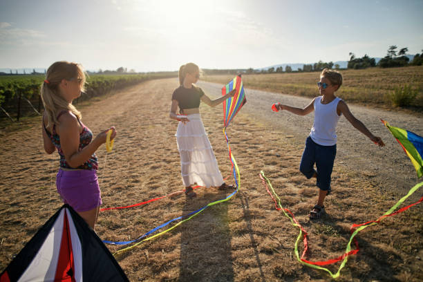 istock Family flying kites on a sunny summer day 1276958196