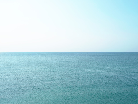 Blue ocean. Small waves. A direct horizon and an immense distance. Clear, blue sky. There is not a single cloud. High quality photo