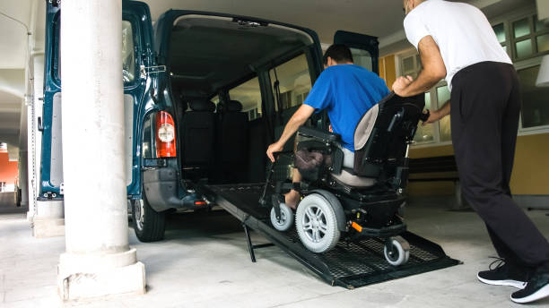 istock Man on wheelchair using vehicle ramp 1276959279