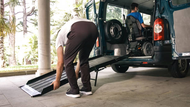 istock Man on wheelchair using vehicle ramp 1276959295