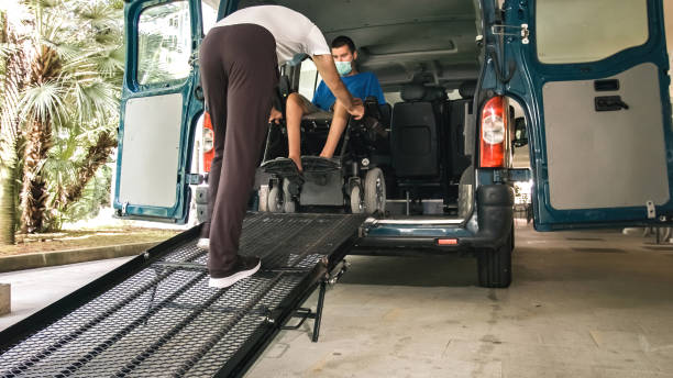 istock Man on wheelchair using vehicle ramp 1276959297