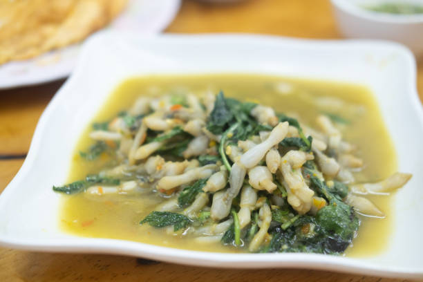 istock Stir-fried Razor clams with chilli and Thai basil on white plate 1276959644