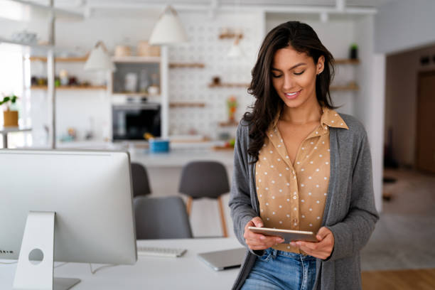 istock Beautiful young woman with digital tablet at home 1276960941