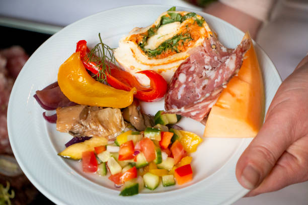 istock Plate with a selection of different appetizers held by one hand 1276962486