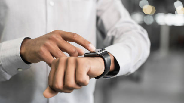 istock Business man using smart watch in office 1276964169