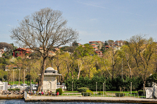 People walking on the sidewalk in the waterfront of the Bosphorus strait at Istanbul city, Turkey.