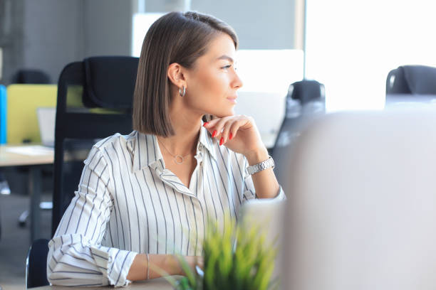 istock Young pretty businesswoman work on notebook computer in the bright modern office. 1276965049