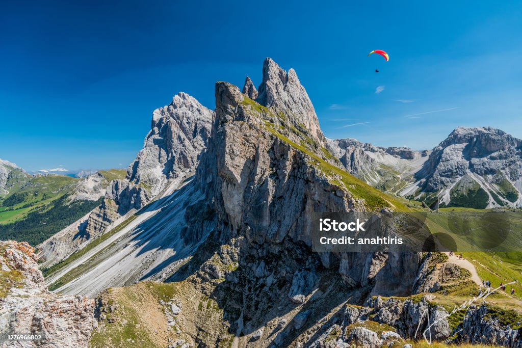 Seceda peak, Dolomites, South Tyrol, Italy Seceda peak with a paraglider, Santa Cristina Val Gardena, Dolomites, South Tyrol, Italy Paragliding Stock Photo