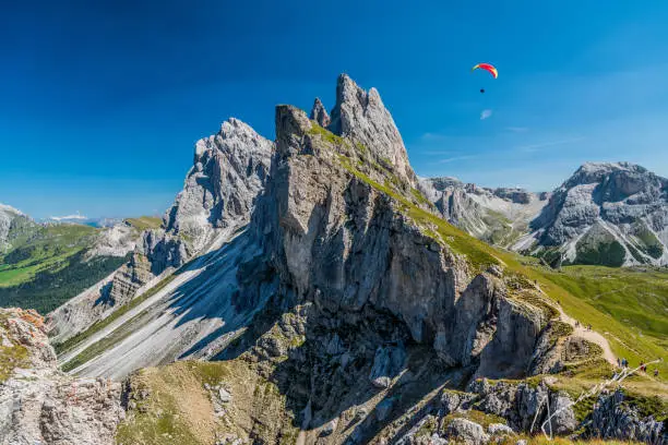 Seceda peak with a paraglider, Santa Cristina Val Gardena, Dolomites, South Tyrol, Italy
