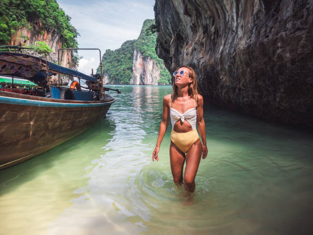 Young woman discovering secret lagoon in Thailand Young woman island hopping in Asia, taxi boat koh chang stock pictures, royalty-free photos & images