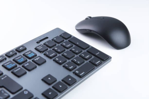 istock Wireless gray keyboard and mouse on a white background close-up. 1276967399