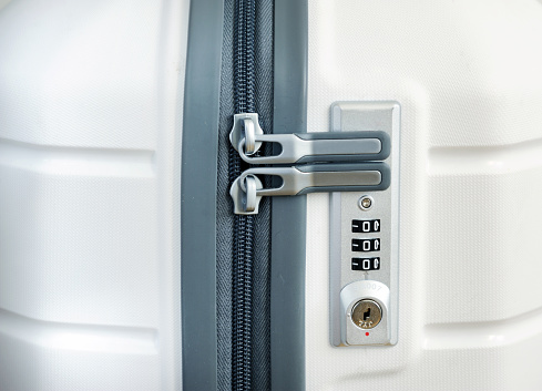 Closeup detail of a suitcase with focus on the lock password number.