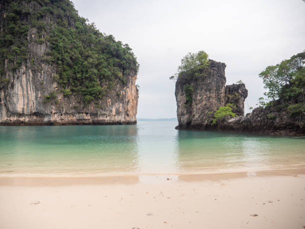 Beautiful green lagoon and white sans beach surrounded by limestone rocks