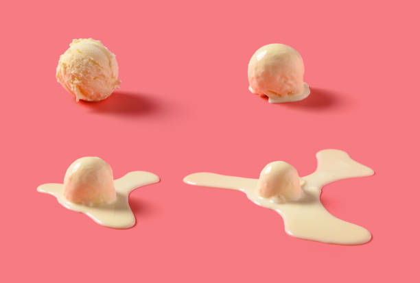 side view vanilla flavor ice cream ball in a melting process on pink background stock photo