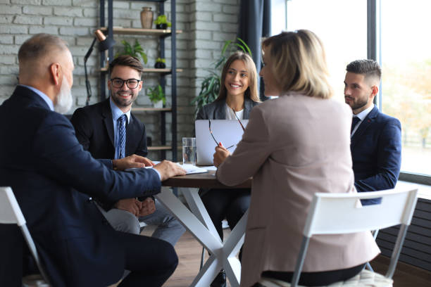 istock Team of business people having discussion at table in creative office. 1276968638