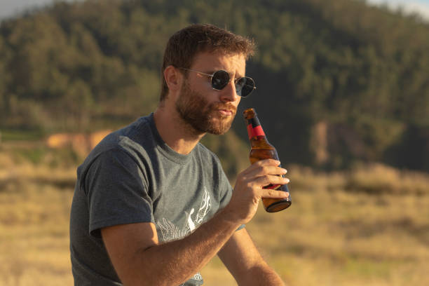 istock A young man drinks beer from a bottle at sunset, Spain 1276968679