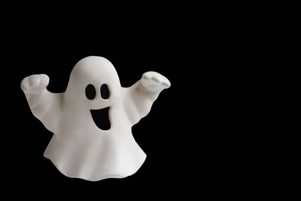 istock Funny white ghost doing boo gesture on black background. Halloween greeting card 1276968690