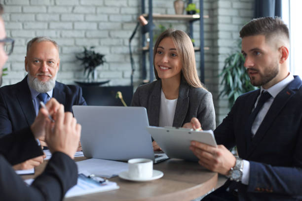 istock Team of business people having discussion at table in creative office. 1276968736