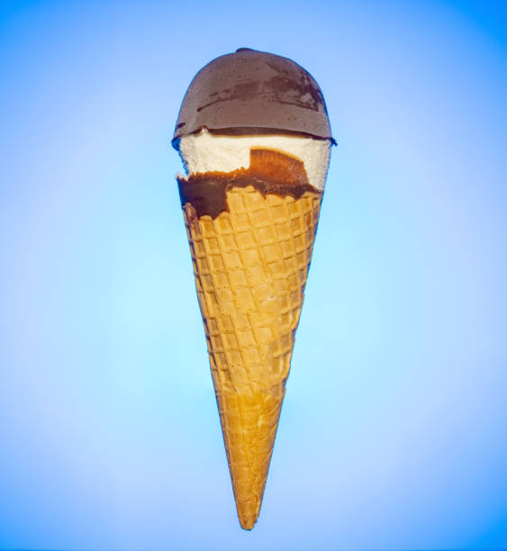 istock fresh chocolate and vanilla flavor ice cream cone on a blue backlit background 1276968771