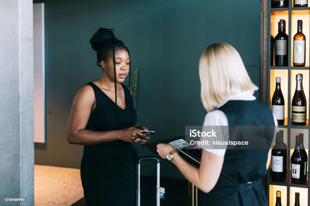 Black Businesswoman entering to first class lounge Black Entrepreneur using her frequent flyer points to use the business lounge Airport Stock Photo